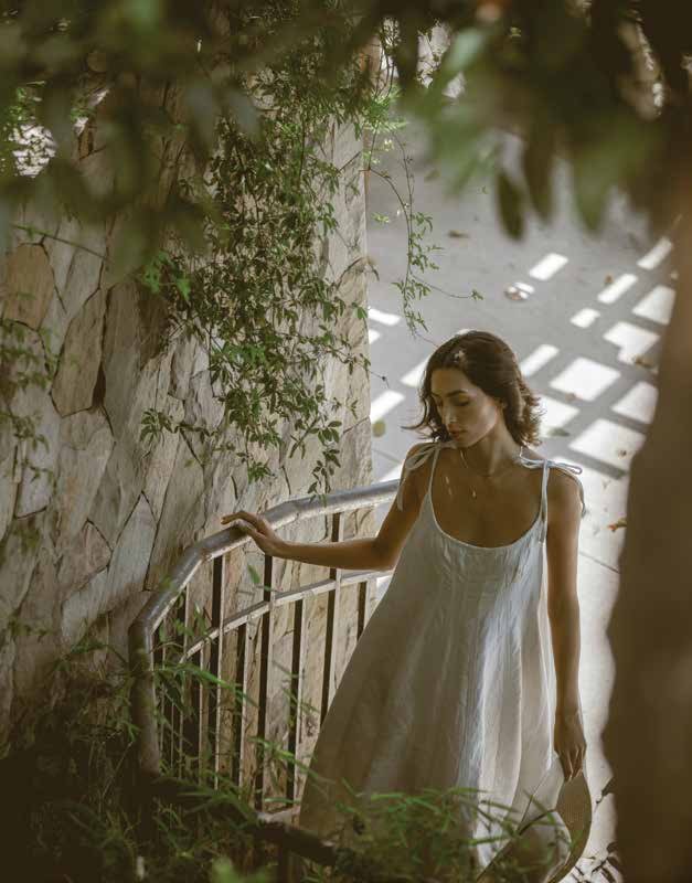 A resident on a planted stone stairway within the landscaped grounds